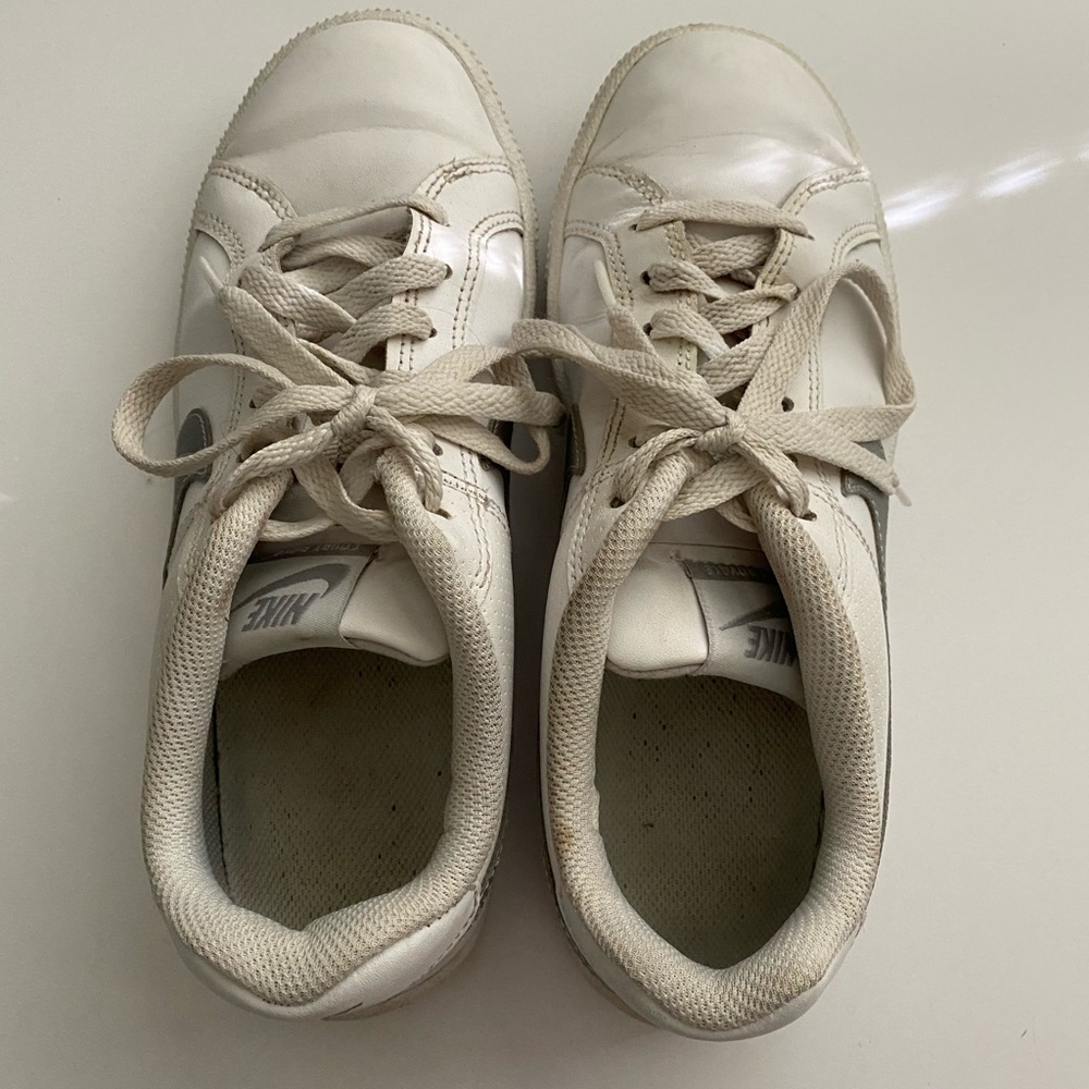 White Nike shoes with a silver swoosh